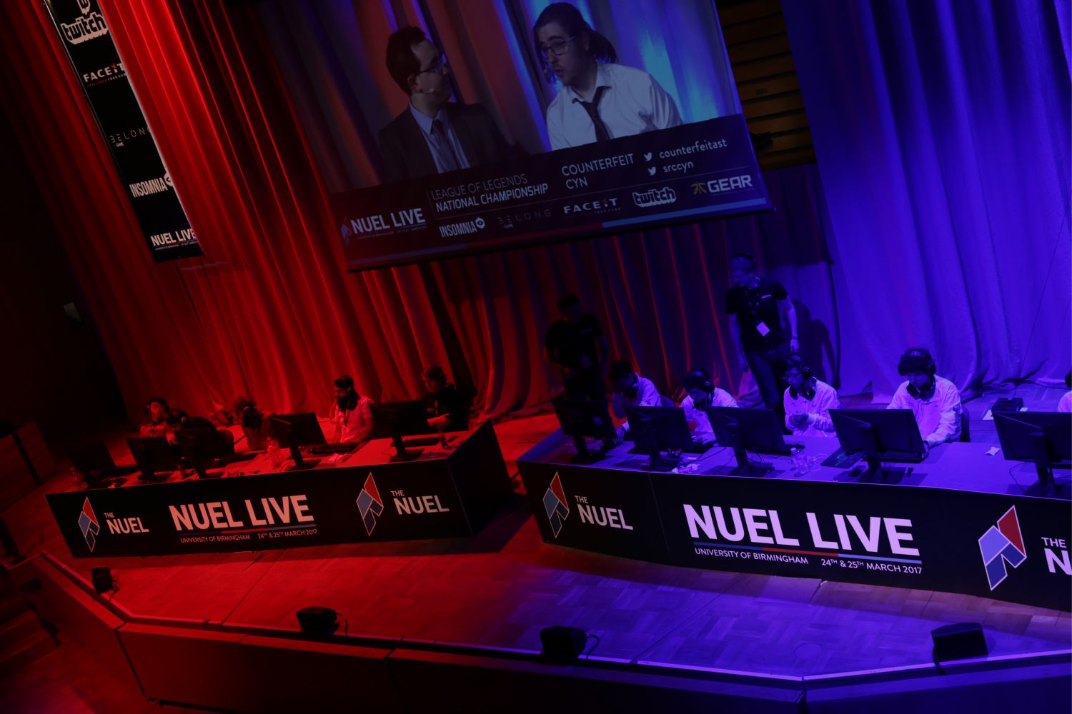 The NUEL logo on banners at a live gaming event.
